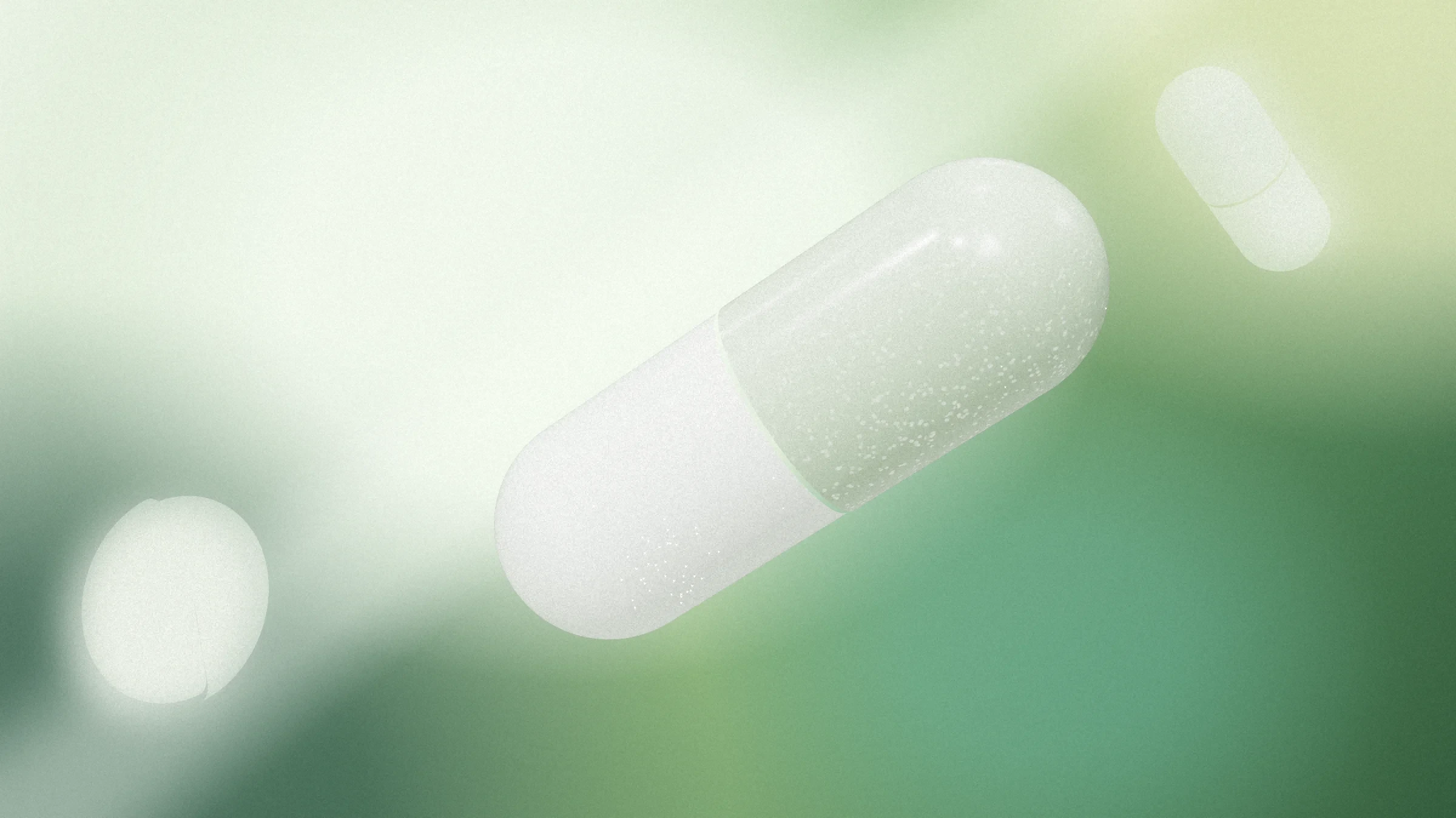 Une gélule blanche et verte penchée, dans un dégradé vert sauge et menthe ; un comprimé et une petite gélule s'effacent dans le fond.